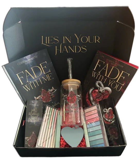 The Cursed Shadow Collector’s Box, open: Fade With Me and Fade With You, a glass cup with a red gem design, bookmarks, page flags and a heart-shaped note pad.