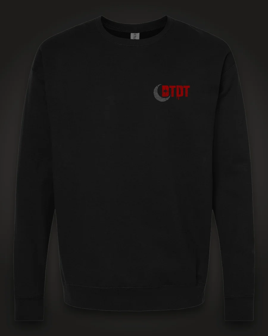 Mockup, front: black crewneck with the DTDT crescent mark in grey and dripping red on the left chest.