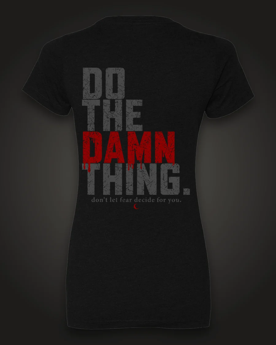 Mockup, back: black women’s tee with “Do the damn thing.” in tall distressed grey letters with “Damn” in dripping red, and “don’t let fear decide for you.” beneath.