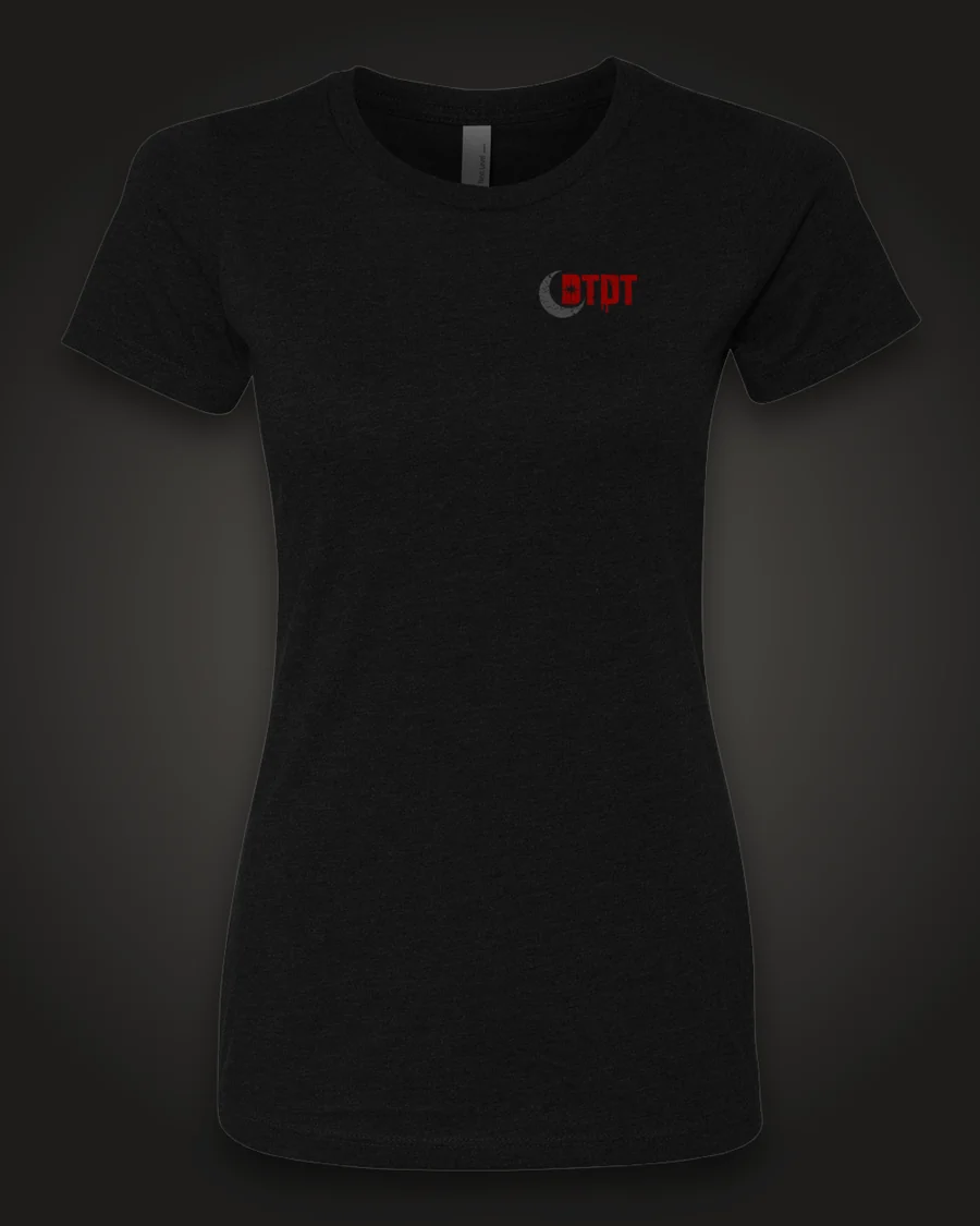 Mockup, front: black women’s tee with the DTDT crescent mark in grey and dripping red on the left chest.