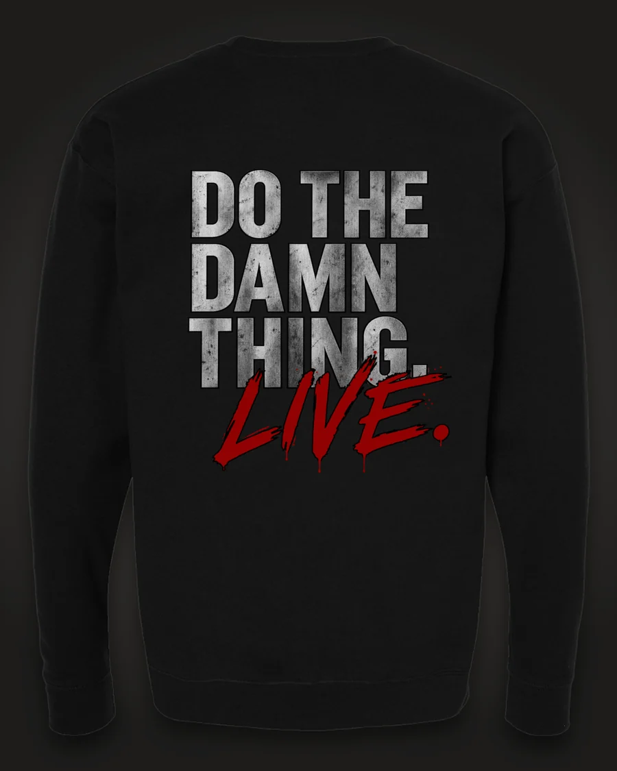 Mockup, back: black crewneck with “Do the damn thing.” in brushed-silver letters with “Live.” brushed across it in red.